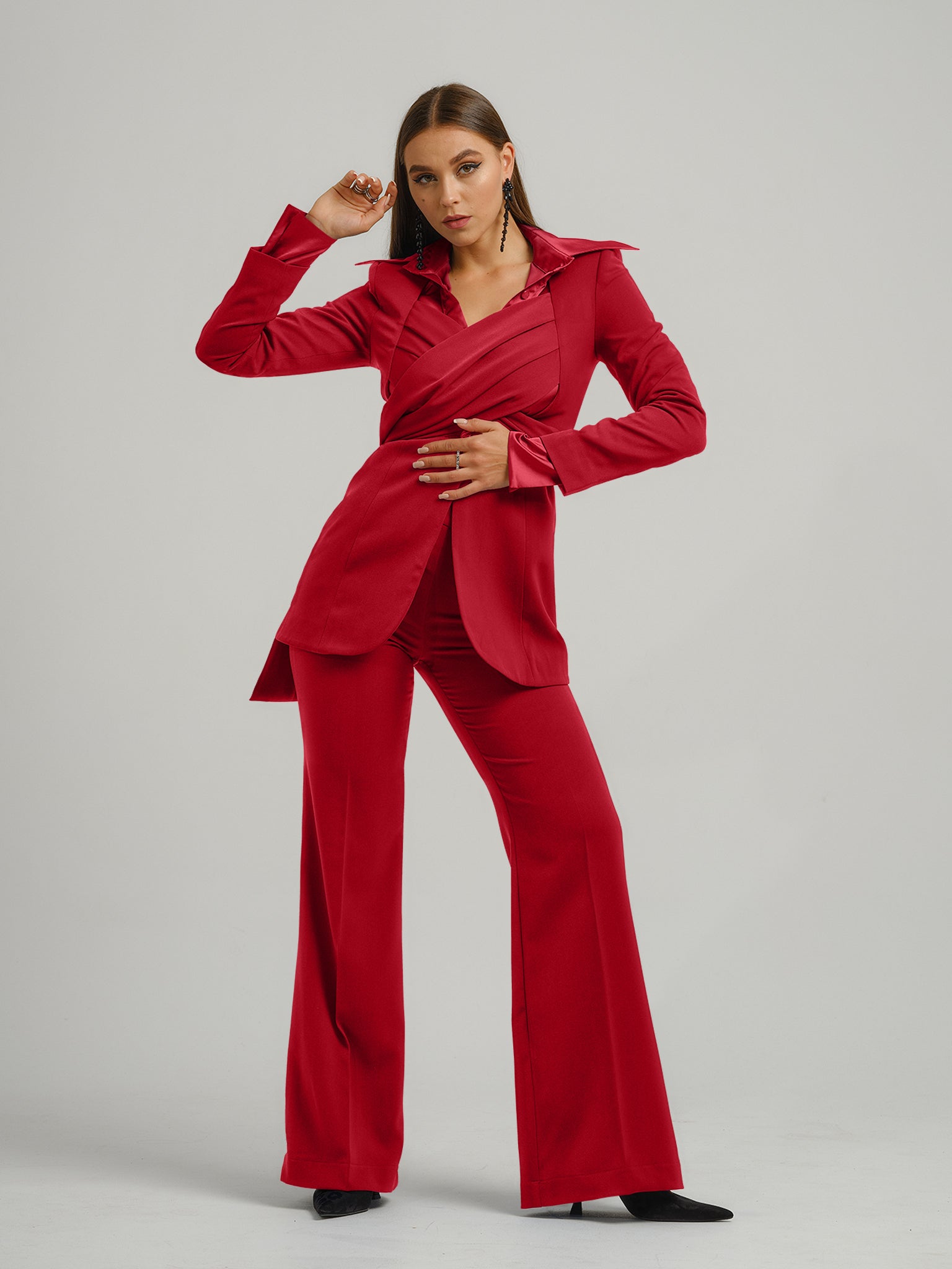 Tia Dorraine Fierce Red Statement Cross Wrap Blazer This thigh-length design reimagines the classic blazer with a generous helping of creative flair. The piece features an impressive cross drape panels that create a sweetheart neckline when tied at the ba