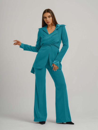 Tia Dorraine Magic Hour High-Waist Flared Trousers These classic flared trousers would fit perfectly in any woman’s capsule wardrobe. With their full length, they can be worn with heeled boots or high heels in the office. The trousers feature a classic wa