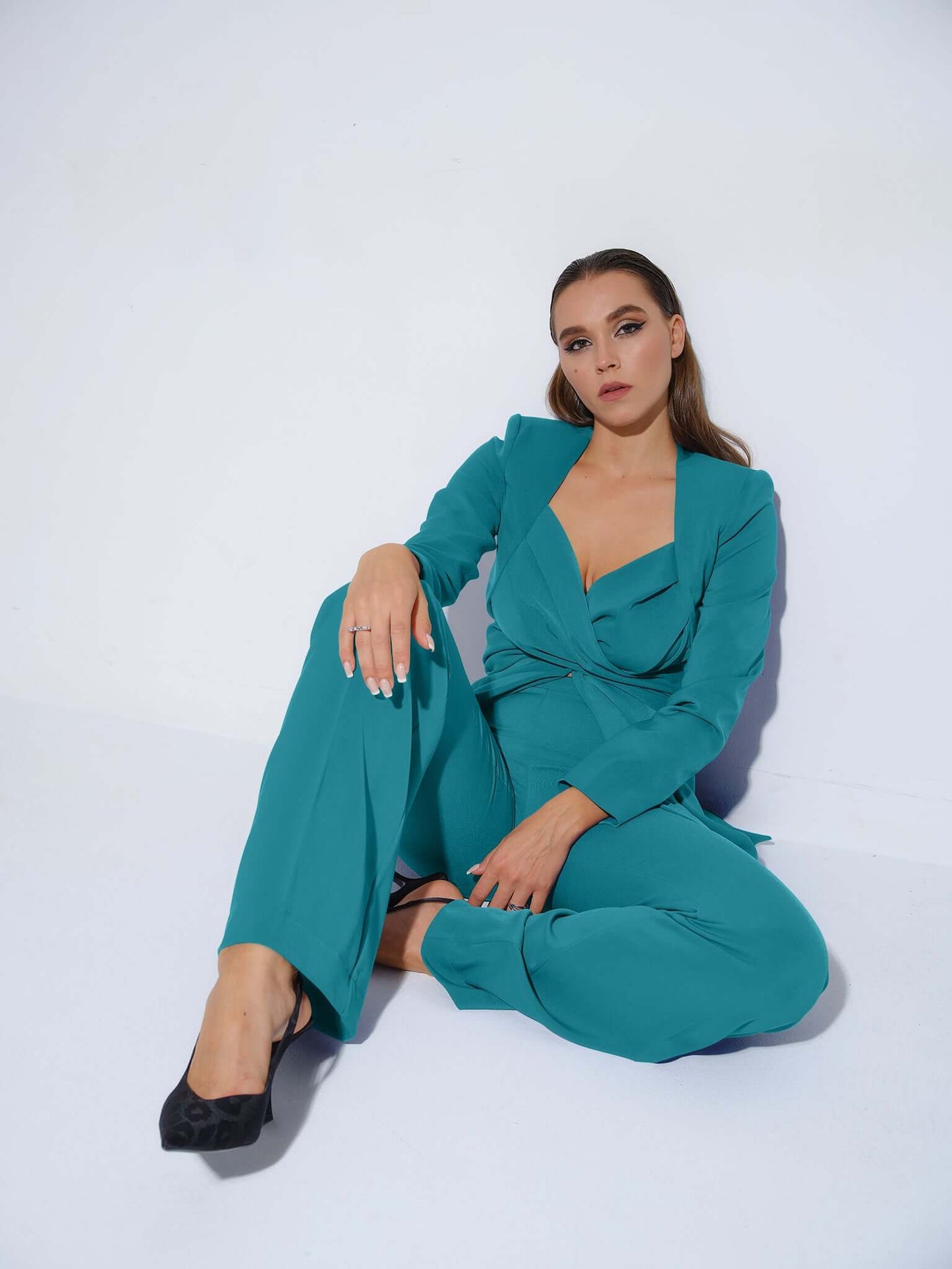 Tia Dorraine Magic Hour Statement Cross Wrap Blazer This thigh-length design reimagines the classic blazer with a generous helping of creative flair. The piece features an impressive cross drape panels that create a sweetheart neckline when tied at the ba