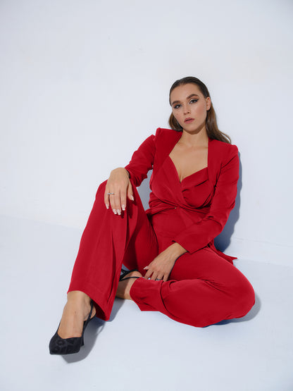 Tia Dorraine Fierce Red Statement Cross Wrap Blazer This thigh-length design reimagines the classic blazer with a generous helping of creative flair. The piece features an impressive cross drape panels that create a sweetheart neckline when tied at the ba