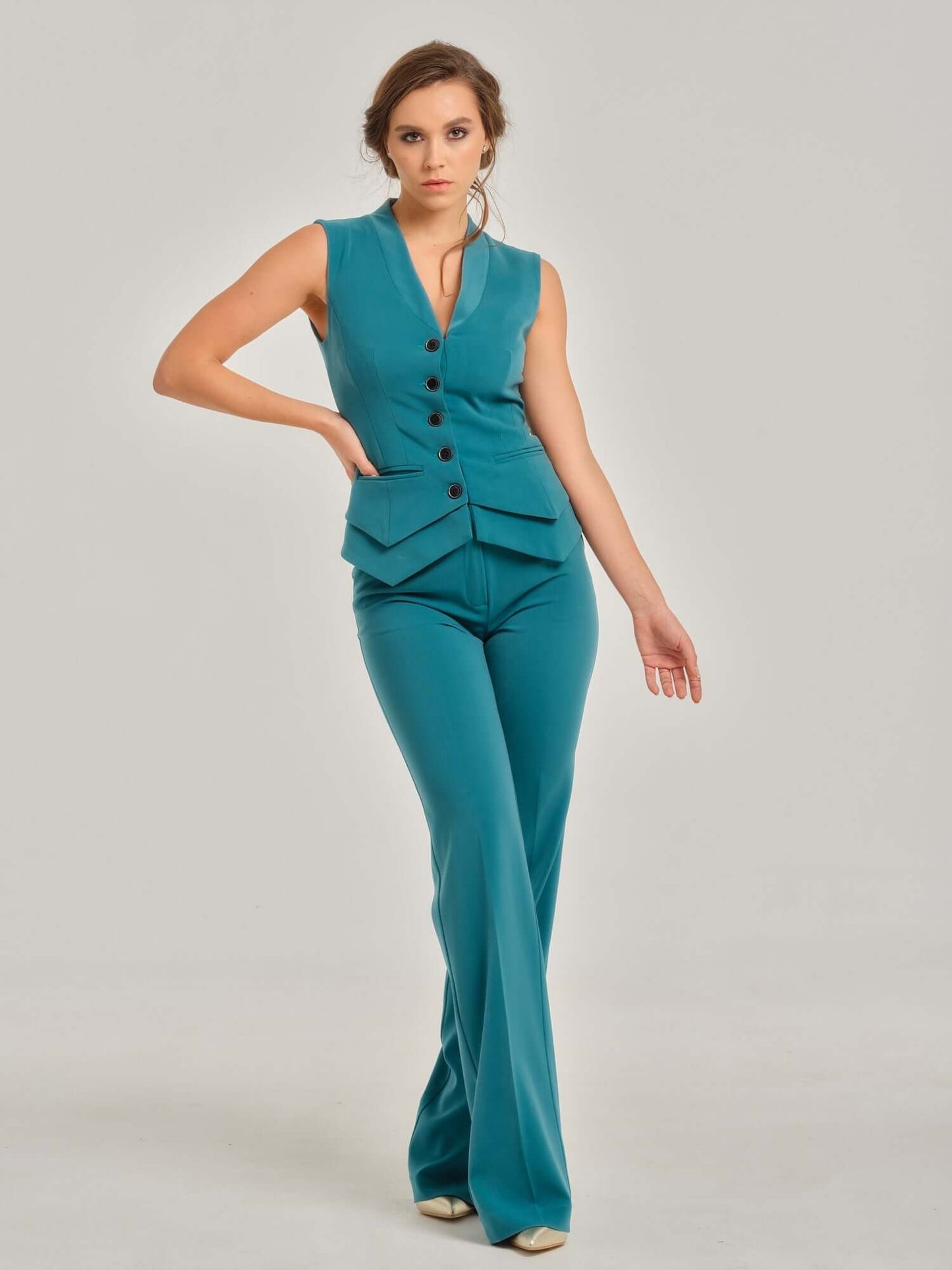 Tia Dorraine Magic Hour Fitted Single-Breasted Waistcoat The Magic Hour V-neckline vest is a classic piece that adds a twist with its sharp details - its double-layered sharply shaped bottom and its beautiful statement buttons. It is comfortable and easy
