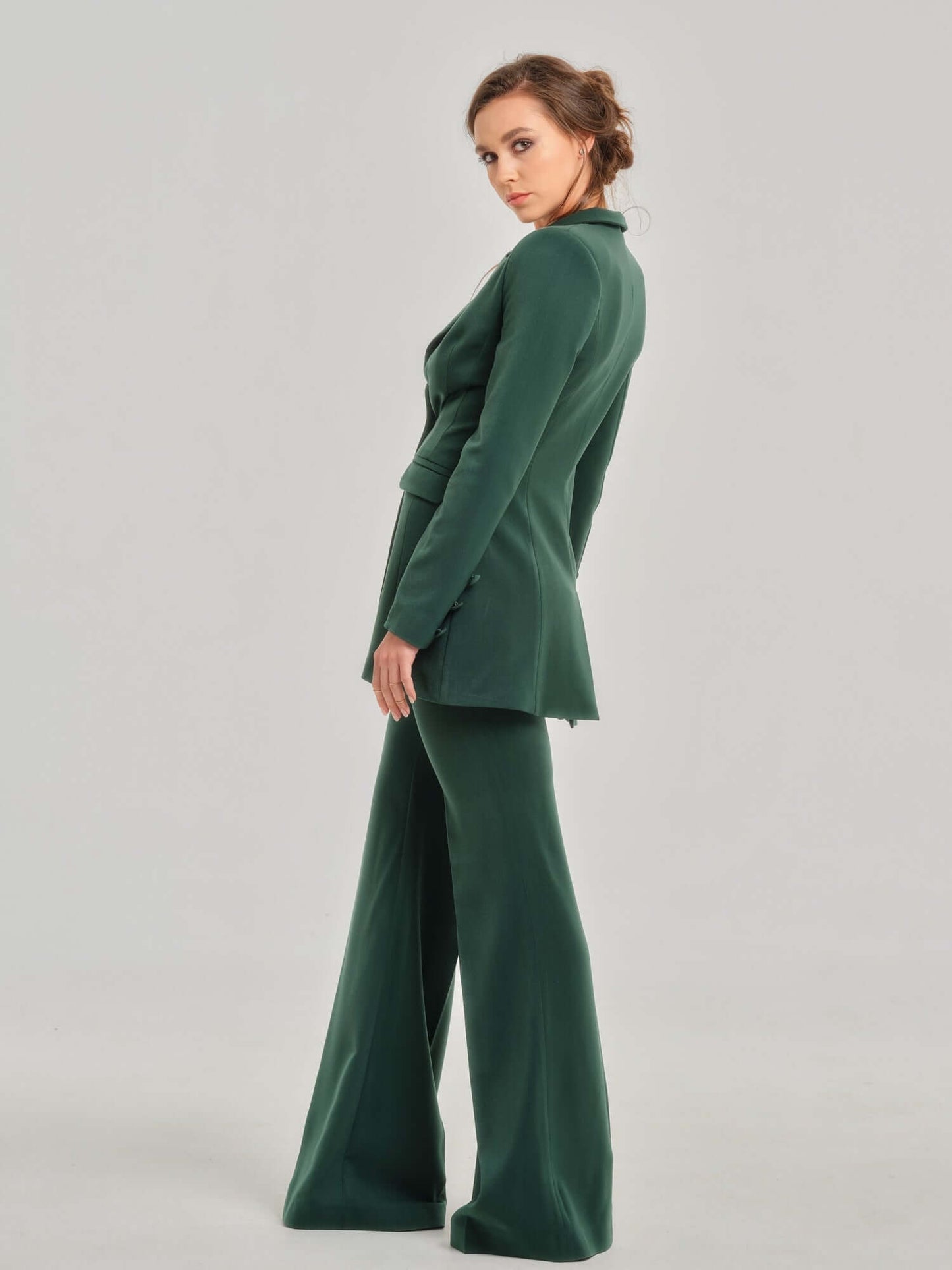 Tia Dorraine Emerald Dream High-Waist Flared Trousers These classic flared trousers would fit perfectly in any woman’s capsule wardrobe. With their full length, they can be worn with heeled boots or high heels in the office. The trousers feature a classic